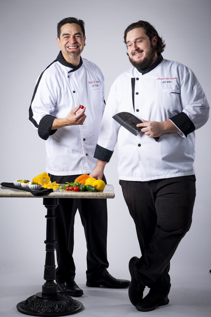 Two Amazen chefs beside a fresh culinary presentation