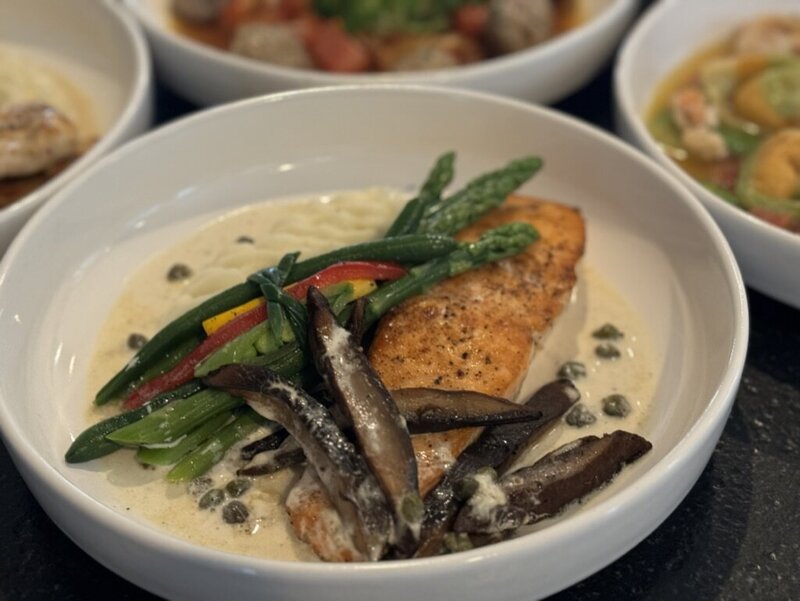 Amazen salmon entrée with vegetables and cream sauce