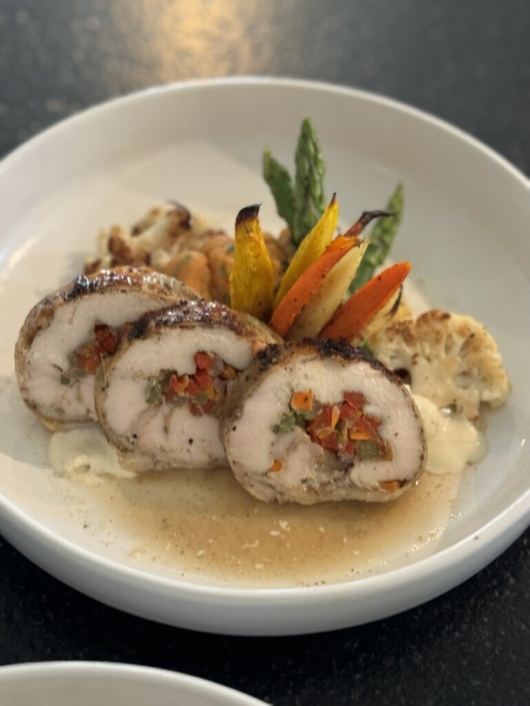 Amazen stuffed chicken entrée with roasted vegetables